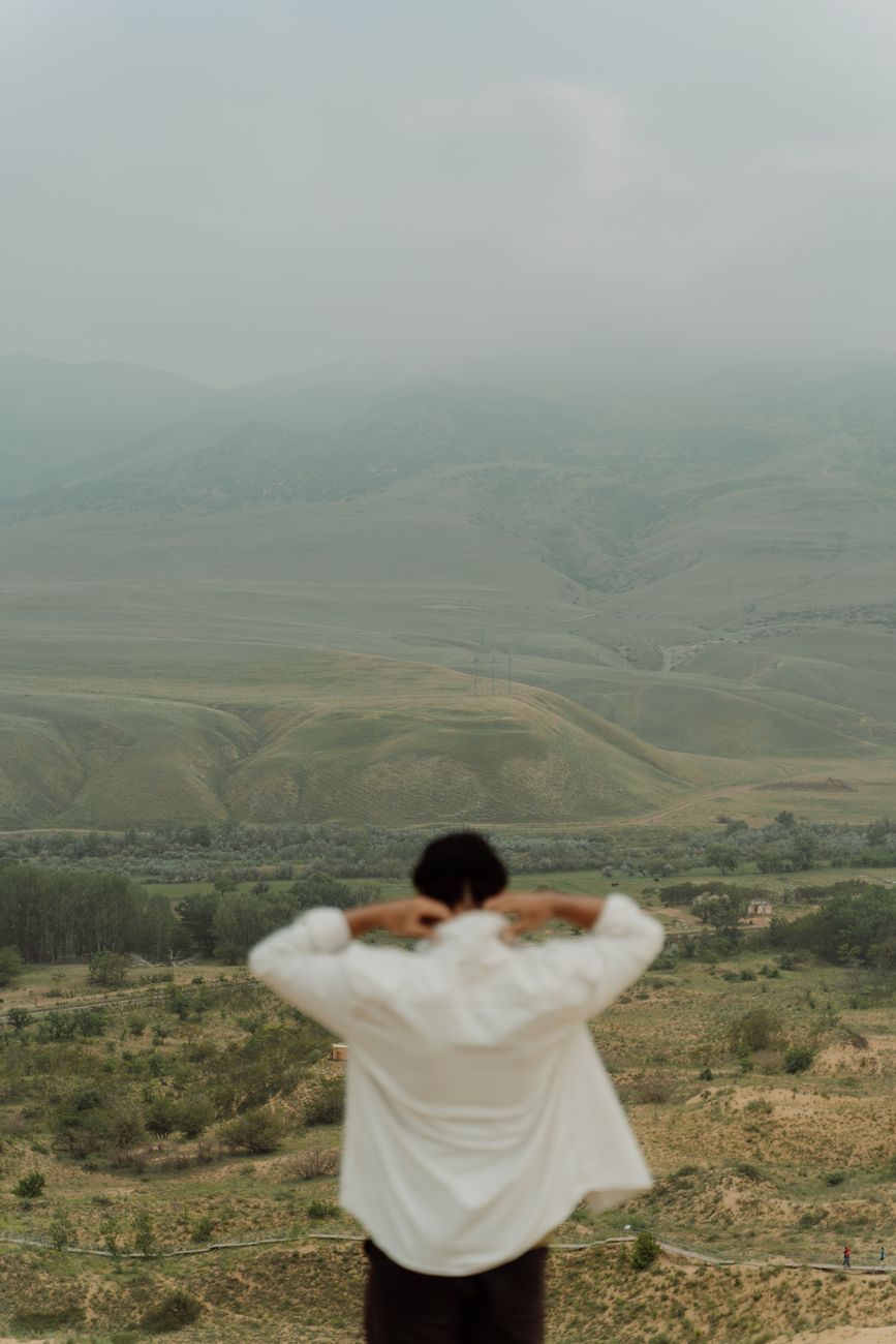 Photographer overlooking a wide mountain valley